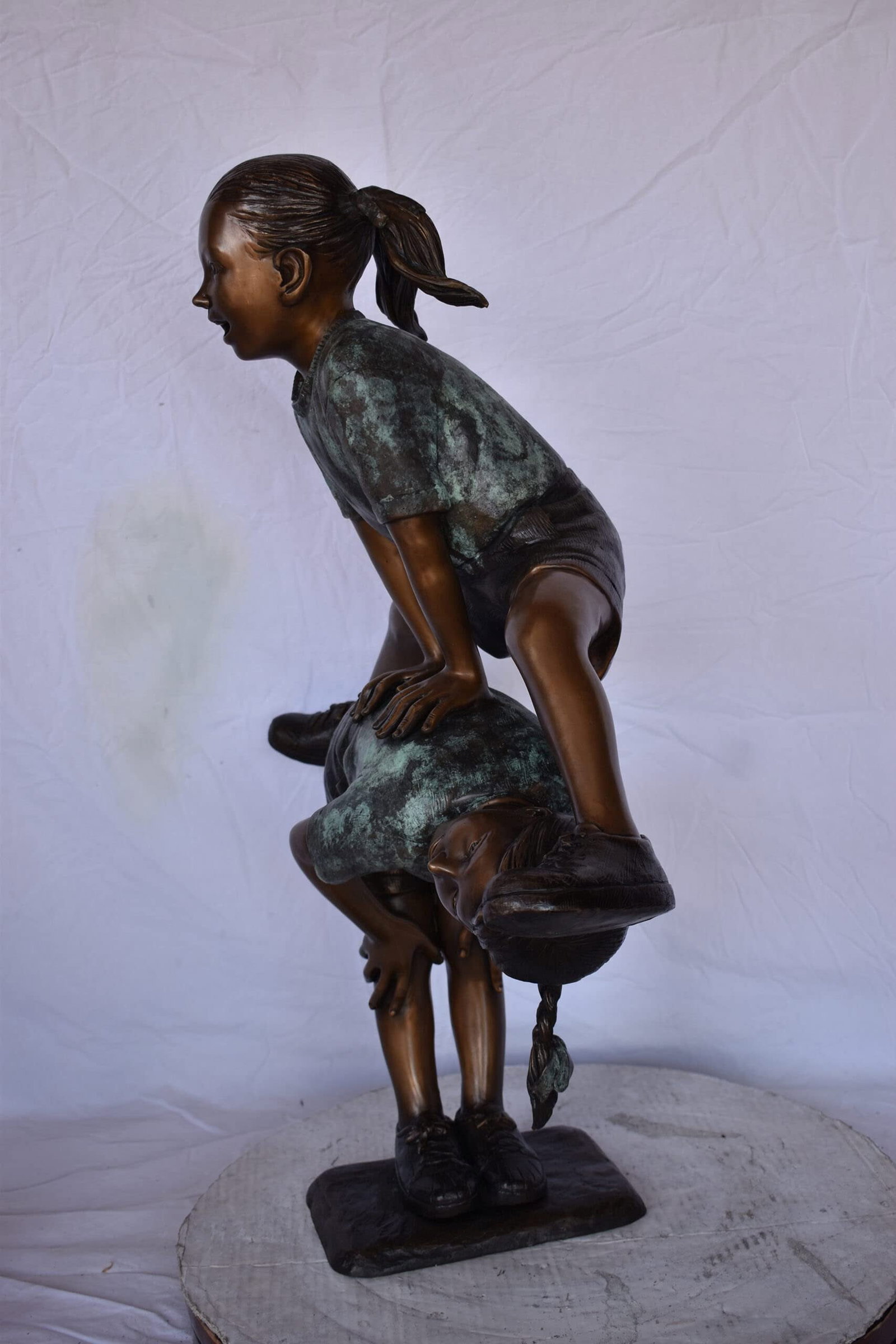 Two Girls Playing Leapfrog Jumping Bronze Statue - Size: 30"L x 14"W x 34"H. - 8