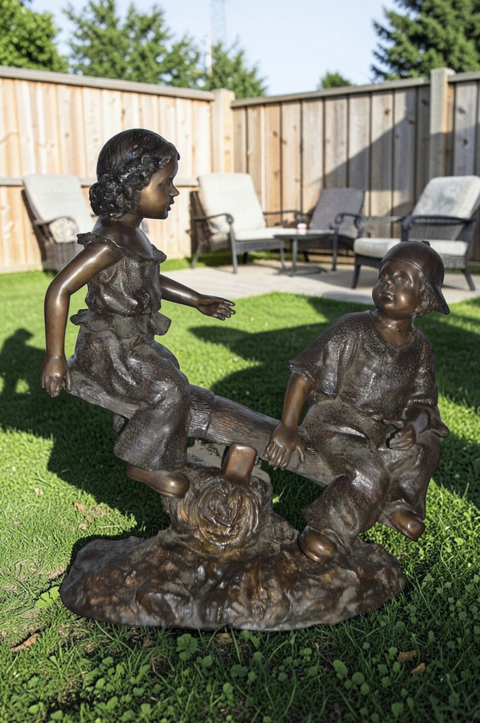A Boy and a Girl Playing Seesaw Bronze Statue - Size: 17"L x 33"W x 36"H. - 2