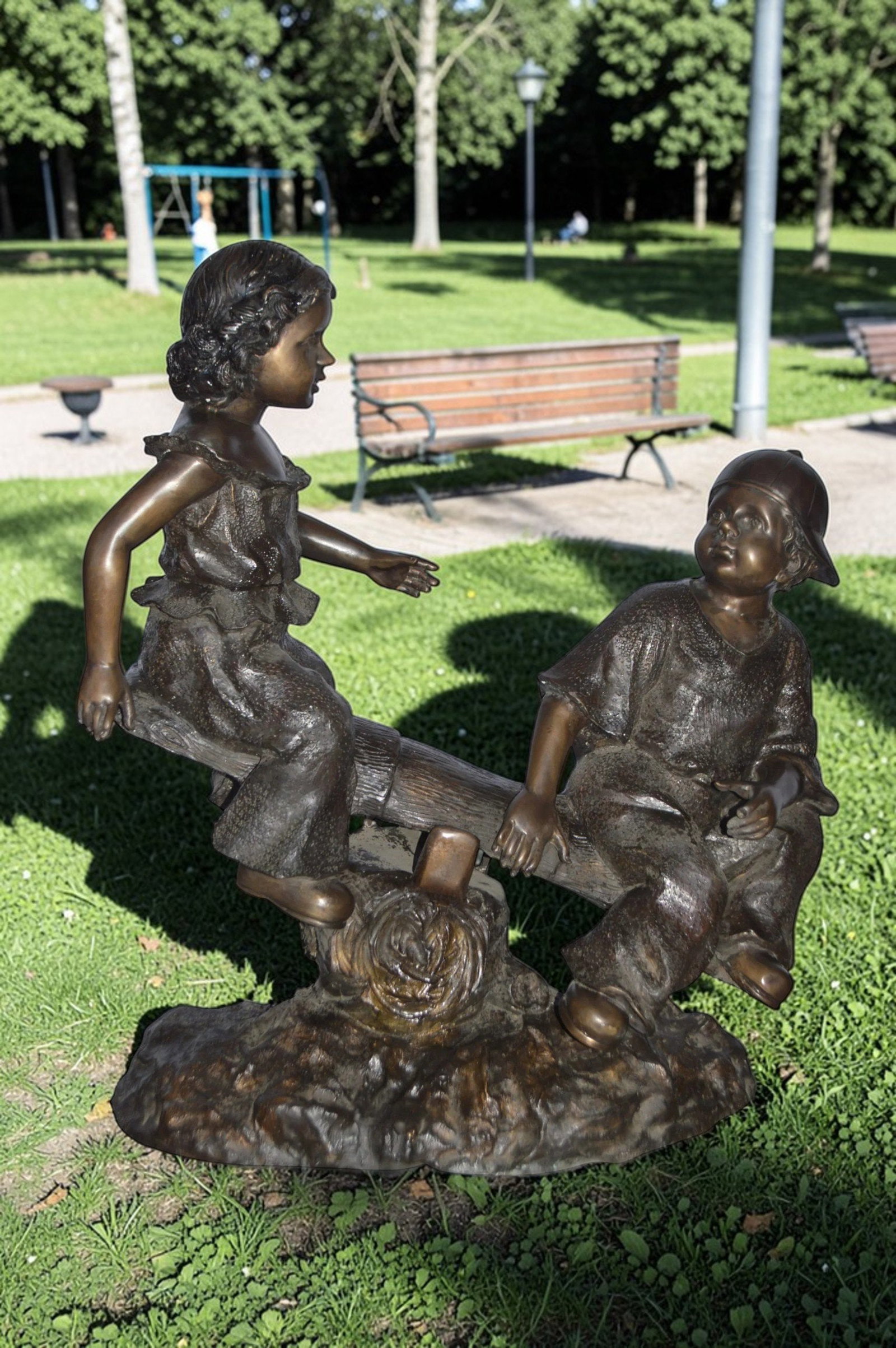 A Boy and a Girl Playing Seesaw Bronze Statue - Size: 17"L x 33"W x 36"H. - 3