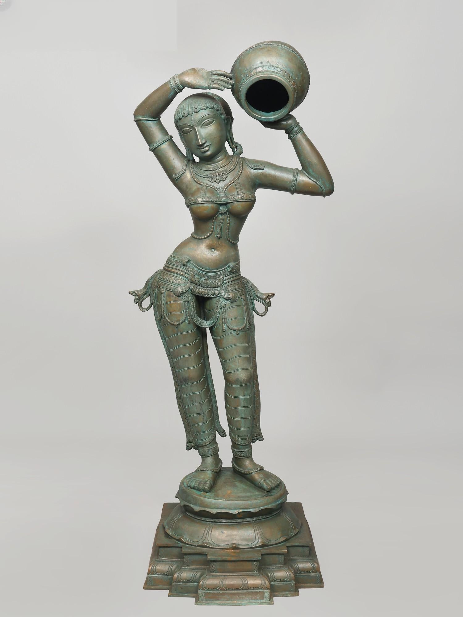 54" Large Apsara Carrying Water Pot | Madhuchista Vidhana (Lost-Wax) | Panchaloha Bronze from: Title: 54" Large Apsara Carrying Water Pot | Madhuchista Vidhana (Lost-Wax) | Panchaloha Bronze from Swamimalai Description: This bronze figure of an Apsara presents a meditation on classical beauty, 