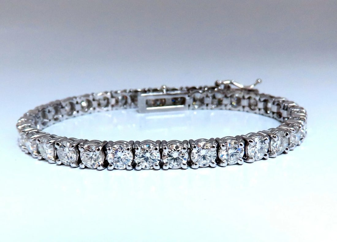 11.45ct Natural Diamonds Tennis Bracelet 14kt Gold Classic Riviera**: Classic Tennis 11.45ct. Natural diamonds bracelet. Round, full cuts H color Si-2 clarity. 14kt. white gold 13.6 Grams. Width of bracelet: 4.6mm 7 inch wearable length safety clasp/ snap lock $48,000 A