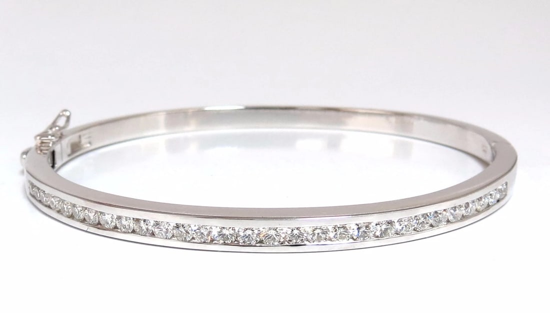 1.30ct natural round diamonds bangle bracelet g/vs channel 14kt**: 1.30ct natural diamonds bangle bracelet Classic Channel Line Rounds & Full cut. G-color & Vs-2 clarity. 14kt. white gold 15 Grams. 3.8 mm wide 7 inch (wearable length) Secure Lock, safety catch and sn