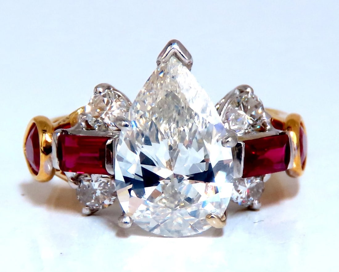 GIA Certified 2.64ct Natural Pear Diamond Ruby ring 14kt *V: Three Stone Pears & Reds 2.64ct. Natural Pear diamond ring GIA Certificate # 5221172632 J-color Si1 clarity good Cut / Full cut Brilliant Very Strong Blue Flouresence 1.50ct Side natural (4) Rubies