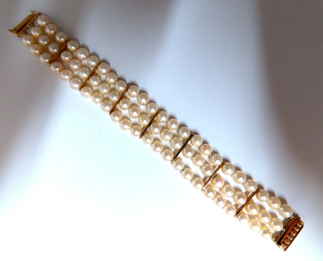 6.5mm Akoya pearls pearls bead bracelet 14kt**: 6.5 mm Akoya pearls bracelet. Three stranded and bar linked. 20mm wide. 14 karat yellow gold 7.5 in Long Comfortable stud beaded clasp ....*. Reserve: $1,860.00 Shipping:</