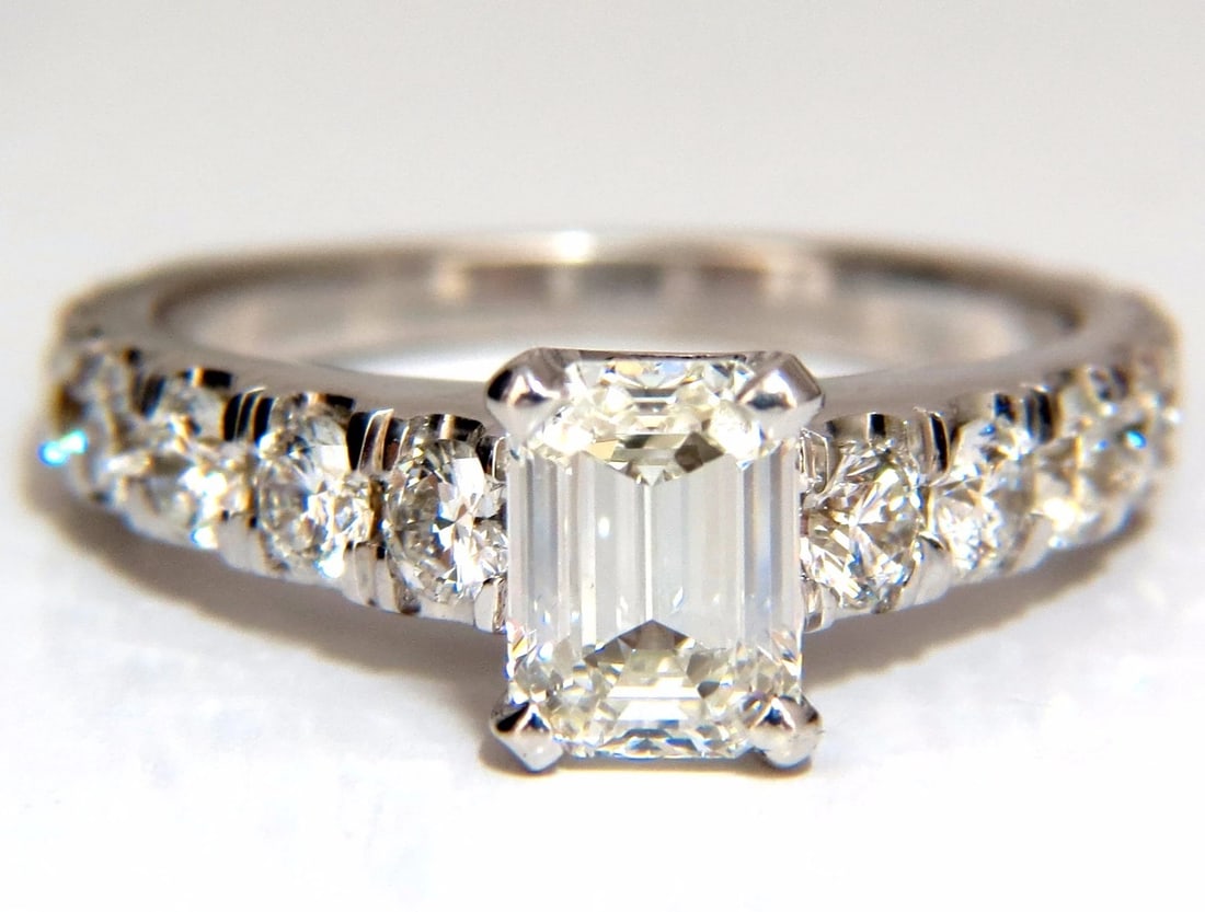 GIA Certified 1.08ct Emerald Cut natural diamond ring 1.20ct. 18kt H/Vs1 *v: GIA Certified Diamond engagement ring. 1.08ct. Natural Emerald Cut diamond GIA Certificate: 1159163625 H color Vs1 clarity (Please see report copy attached) Side diamonds: Rounds, 1.20ct G-color, Vs-2