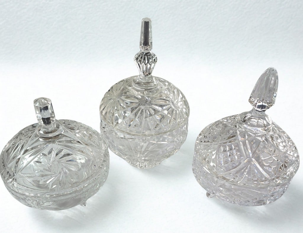 Set of Three Cut Crystal Covered Candy Dishes: This elegant set features three matching cut crystal covered candy dishes, each adorned with a sophisticated starburst and geometric pattern. The dishes are crafted from clear, sparkling crystal,