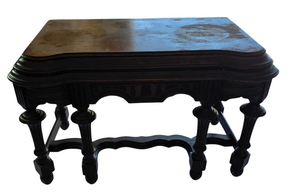 Antique Carved Oak Games Table: This antique games table is crafted from dark-stained oak and features a rich, dark patina. The rectangular top has subtly scalloped edges and a hinged mechanism, suggesting it opens to reveal a game 