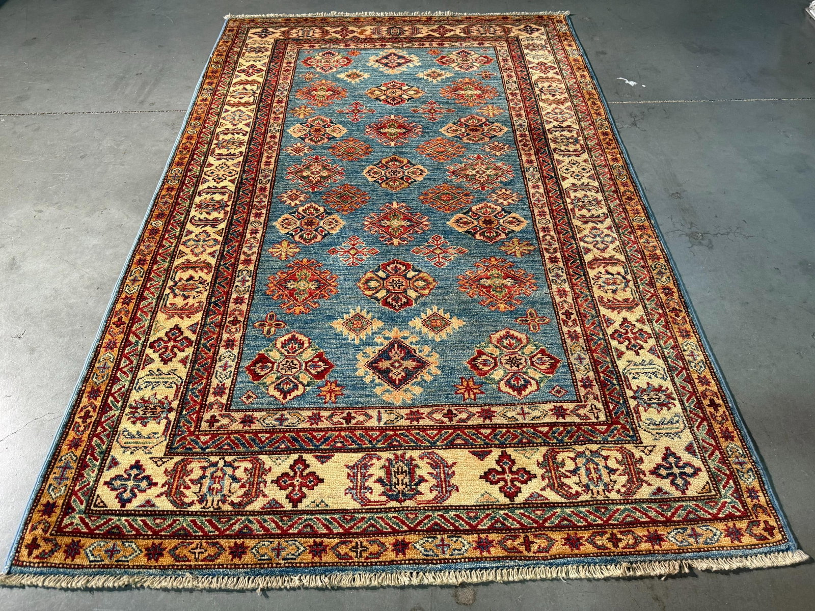 Fine Super Kazak Rug 4.1x6.1: Title:Fine Super Kazak Rug 4.1x6.1 Description:4.1x6.1 Super quality Kazak Rug in Antique finish , hand spun and hand knotted in Pakistan 100% natural Veggey Dye wool Pile , in Silky blue , Ivory and