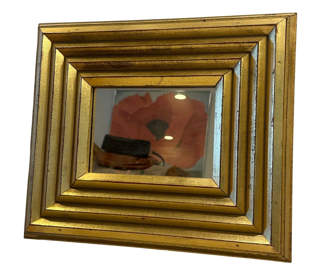Giltwood Beveled Wall Mirror: This contemporary giltwood wall mirror features a beveled frame with stepped detailing, presenting a rich, distressed gold finish. The central mirror is flat. The reverse is fitted with an attached