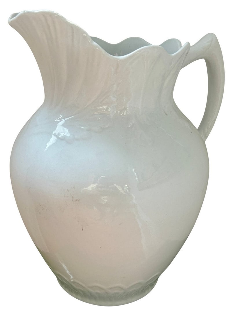 Early 20th Century Bone White Ceramic Pitcher with Scalloped Rim, Marked "Virginia": This elegant pitcher features a classic, bulbous body and a distinctive scalloped rim and spout. The handle has a graceful, curved form. The pitcher has a simple yet timeless aesthetic, making it suit