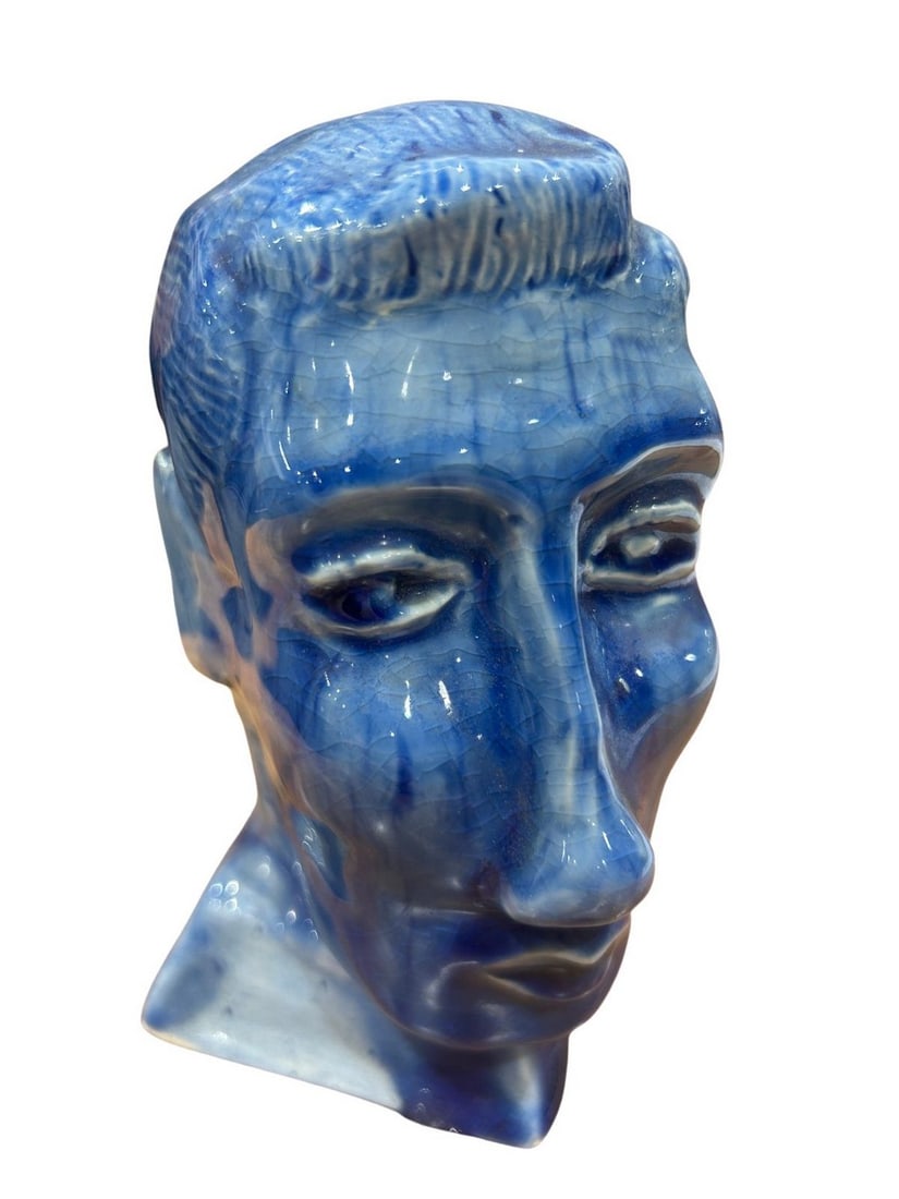 Blue Glazed Ceramic Male Bust: This captivating ceramic bust is rendered in a striking royal blue glaze with a distinctive crackle finish. The bust focuses on the head and neck, featuring coiffed hair and a contemplative facial exp