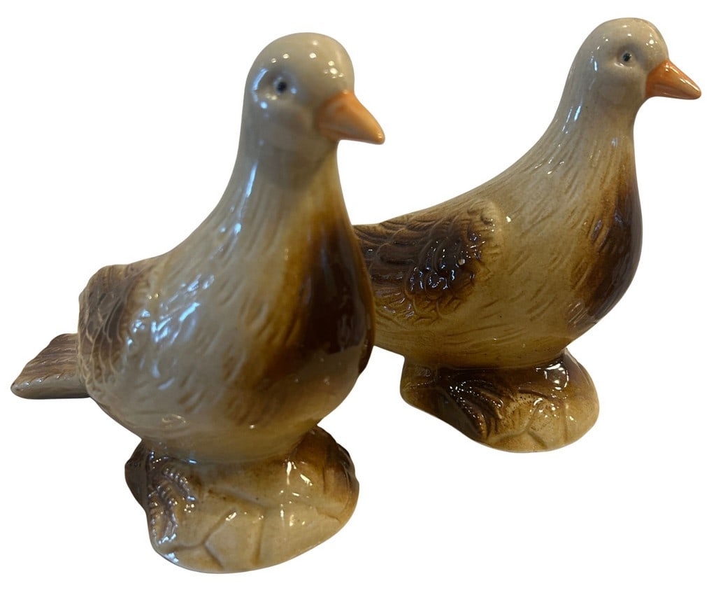 Pair of Made in Brazil Ceramic Bird Sculptures: This lot features a pair of charming ceramic bird sculptures, likely from the mid-20th century, crafted in Brazil. Each bird is depicted in a stylized manner, with a graceful elongated neck and a comp