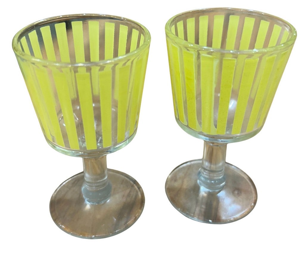 Pair of Mid-Century Modern Yellow Striped Dessert Glasses: A charming pair of mid-century modern dessert glasses, likely dating from the 1950s or 1960s. These glasses feature a distinctive yellow and clear striped design, characteristic of the atomic or