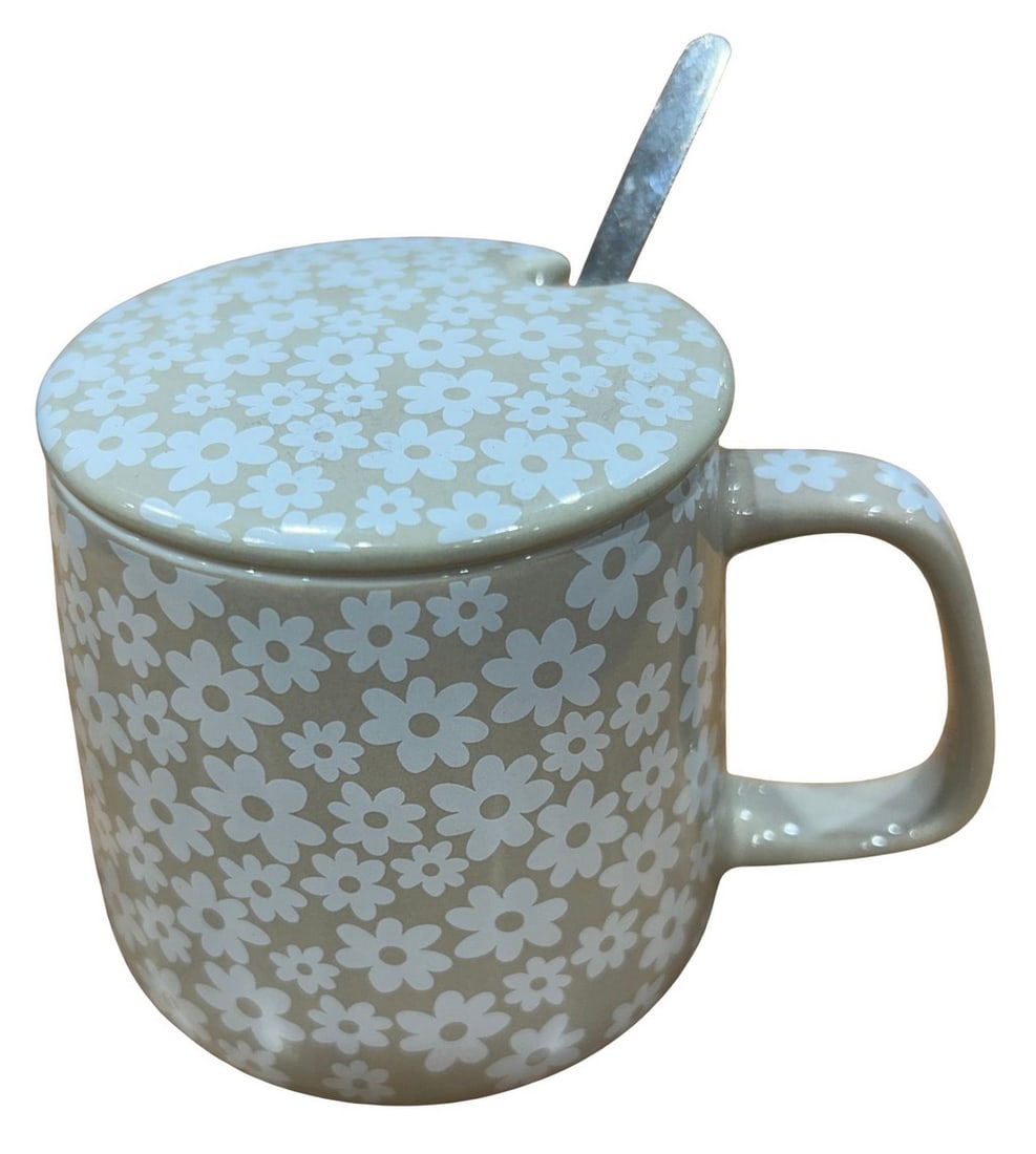 Floral-Patterned Ceramic Mug with Lid and Spoon: This charming ceramic mug features a delightful floral pattern in white on a light tan background. It comes with a matching lid, designed with a small indentation for the included metal spoon,