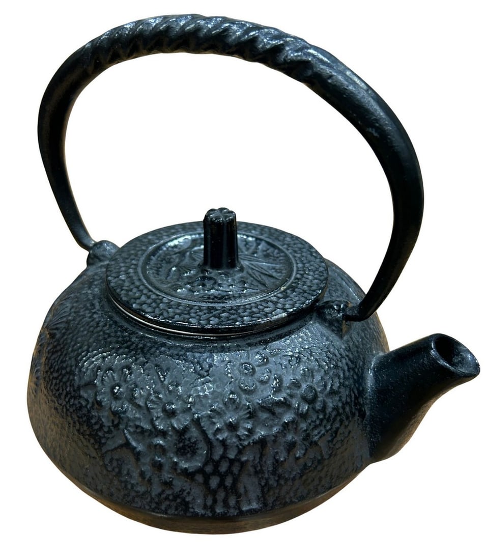 Japanese Cast Iron Tetsubin Tea Kettle with Infuser: This is a traditional Japanese cast iron tetsubin tea kettle, distinguished by its textured, hammered exterior and classic black finish. The kettle features a robust, sculpted handle that facilitates 