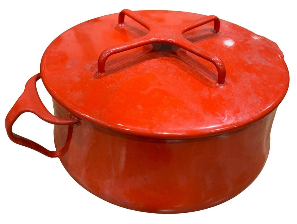 Vintage Red Enameled Cast Iron Dutch Oven: A vintage bright red enameled cast iron Dutch oven like Dansk. This round pot features a vibrant orange exterior, a white enameled interior, and a matching red lid with an "X" shaped handle. There are