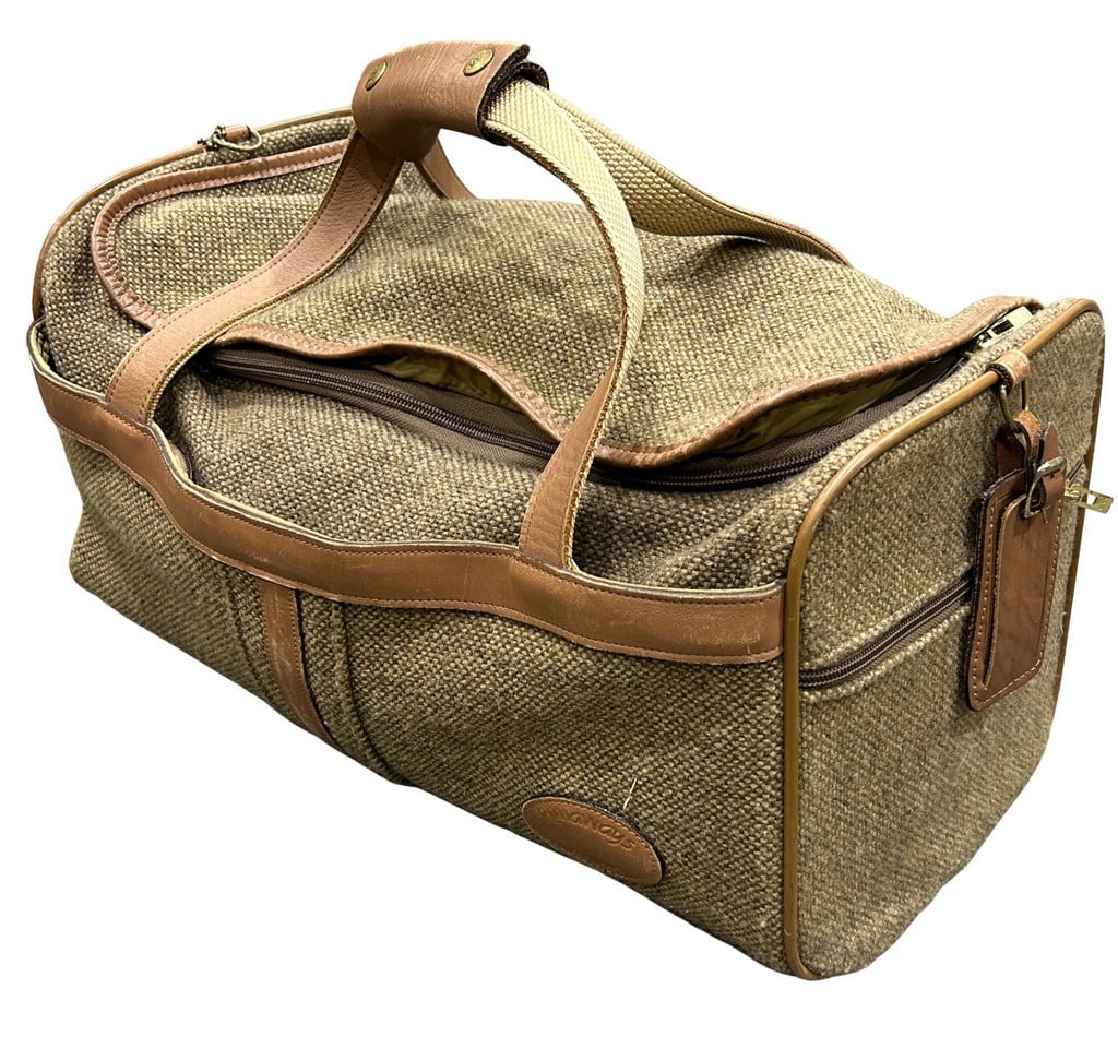 Vintage Runaways Travel Duffle Bag / Weekender: This vintage Runaways travel bag features a durable woven fabric in a neutral brown/tan hue, accented with tan leather trim and handles. The bag has a classic duffle bag silhouette with a full zipper