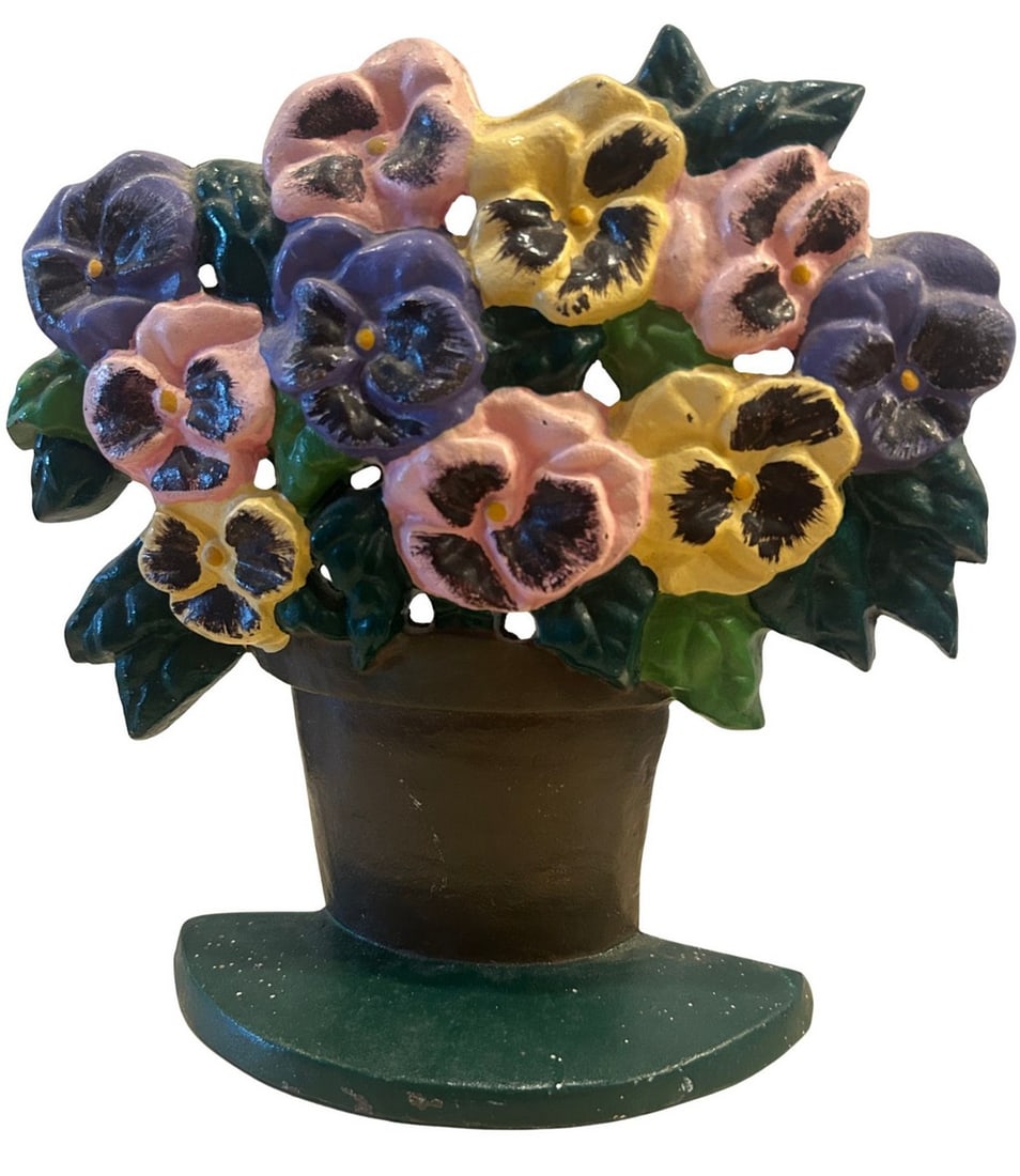 Cast Iron Pansy Doorstop: A charming cast iron doorstop in the form of a vibrant bouquet of pansies, presented in a classical urn or pot. The pansies feature a delightful mix of colors including purple, yellow, and pink, accen