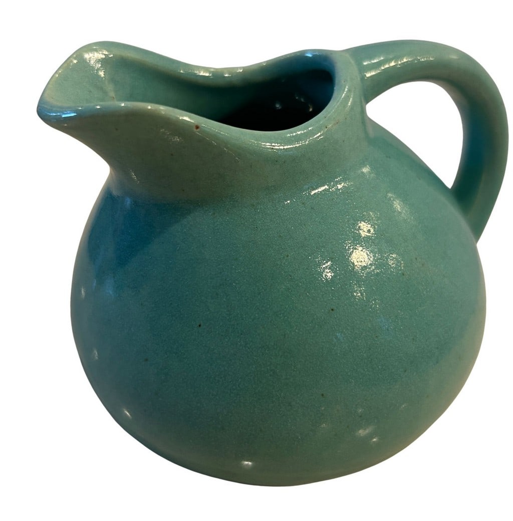 Teal Glazed Ceramic Creamer or Small Pitcher: A charming small ceramic pitcher or creamer, likely mid-20th century, featuring a vibrant teal-blue glaze. The piece has a rounded body, an applied handle, and a square-shaped mouth with a spout for