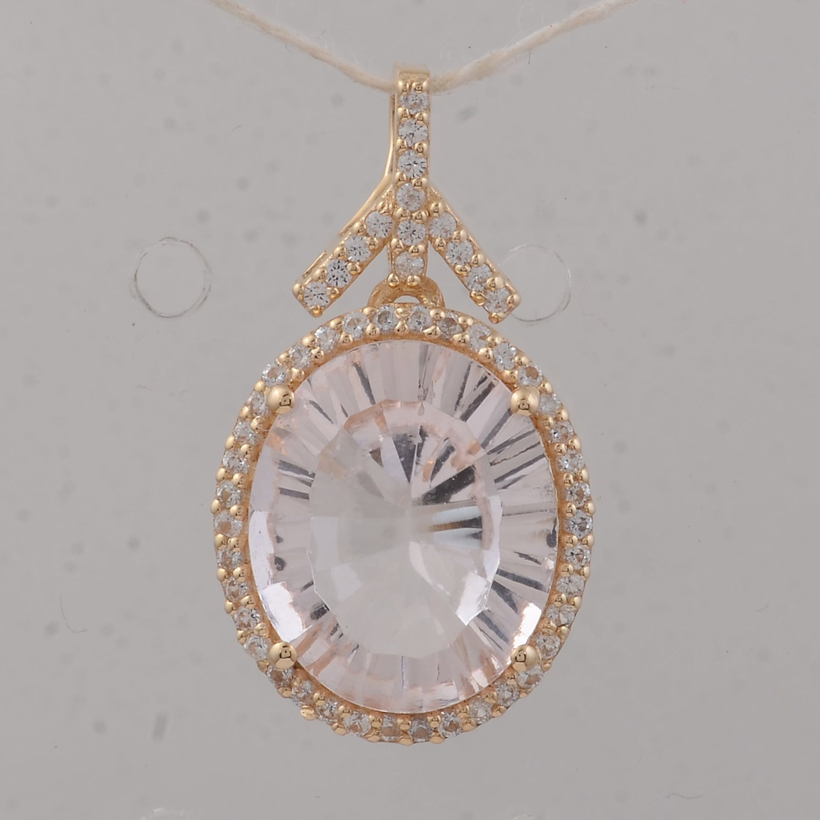 3.66 Ct Oval Morganite 9K Gold Pendant: 3.66 Total Carat Morganite 9K Gold Pendant Specifications: Total Weight 1.94 g Center Gemstone Morganite Gemstone Carat Weight 3.42 Carats Gemstone Measurements 12X10X5.40 mm Additional Gemstones Whit