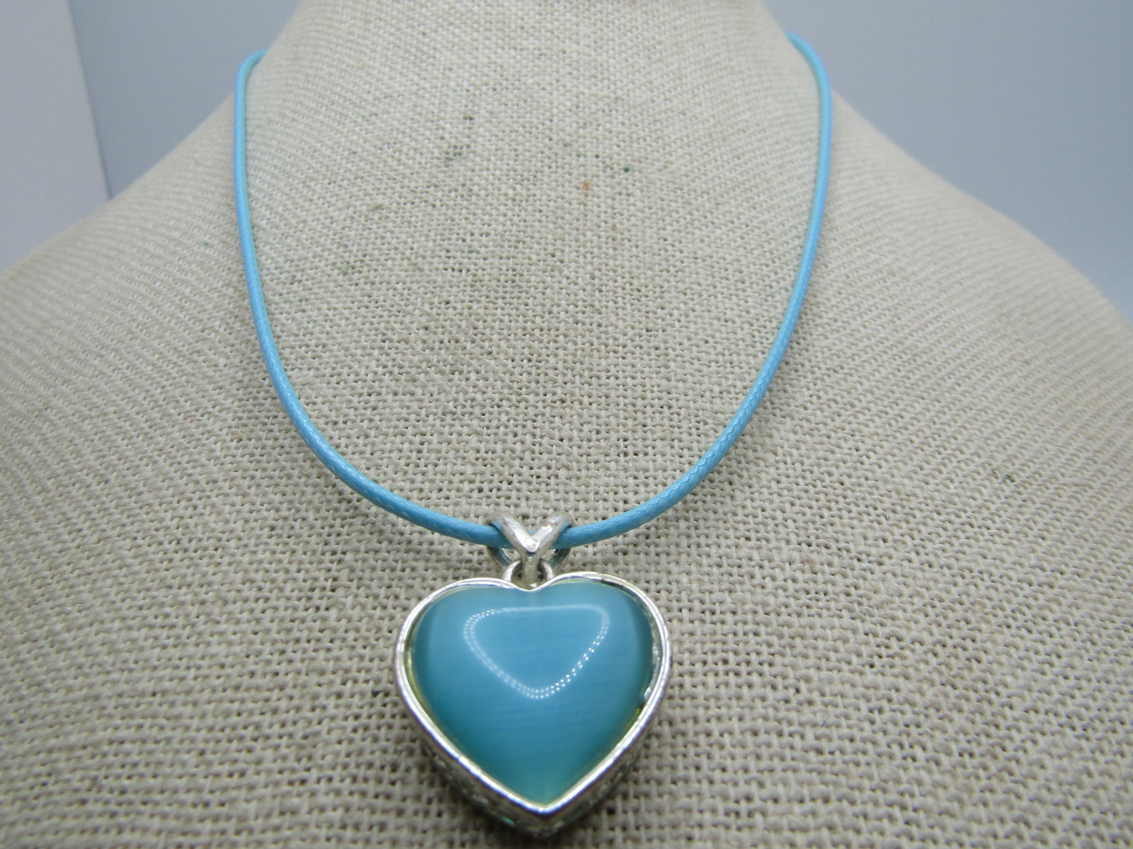 Aqua Faux Mother-of-Pearl Heart Necklace, 20" Aqua Cord: Title: Aqua Faux Mother-of-Pearl Heart Necklace, 20" Aqua Cord Description: Aqua Faux Mother-of-Pearl Heart Necklace, 20" Aqua Cord. Silver tone teal heart that looks like mother-of-pearl. It is appx.