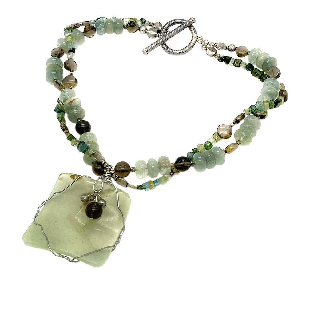 Nephrite and Smoky Quartz Necklace with Pendant: This double strand necklace with pendant was created with nephrite and smoky quartz beads attached to a hand wired nephrite slice as pendant. It comes with a large toggle clasp. Dimensions: 18 inch ne