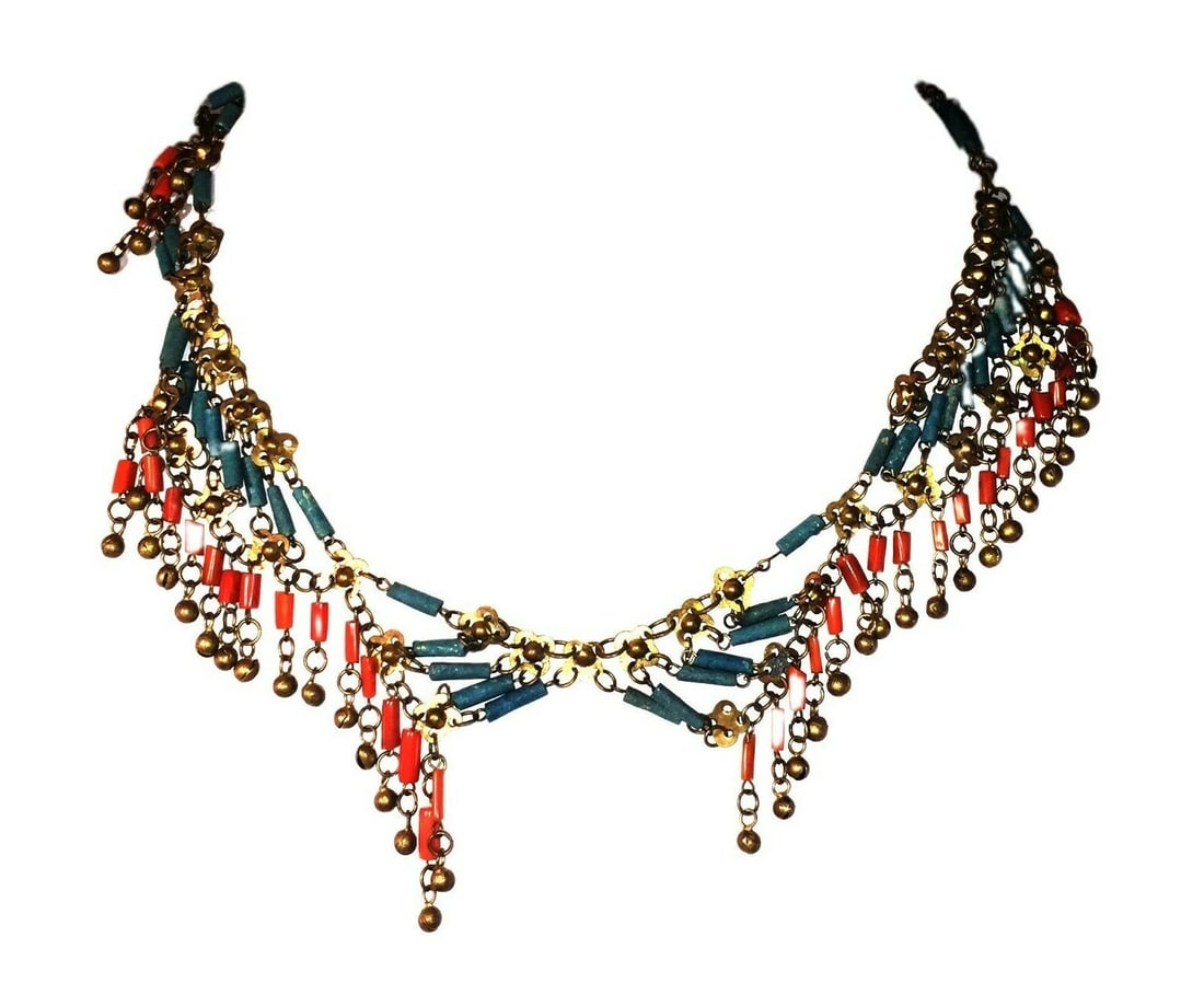 Egyptian Revival Asymmetrical Red Coral Brass Faience Necklace: Title:Egyptian Revival Asymmetrical Red Coral Brass Faience Necklace Description:Amazing and rare brass, natural red coral, and blue faience glass fringe necklace. Circa 1915. Red coral cylinder beads