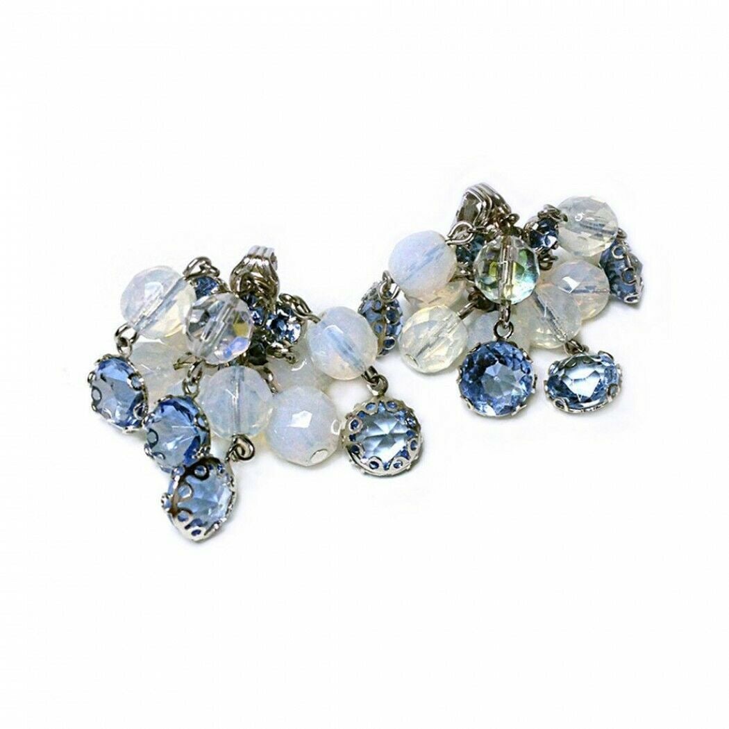 Carnegie Blue Cascading Earrings: This is a pair of clip-on Carnegie blue cascading earrings with rhodium plated backs. They have prong set faceted blue crystal and opalescent crystal (simulate moon stones) beads dangling and linked