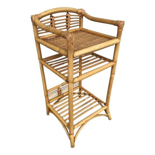 Restored 1950s Mid-Century Rattan & Wicker Three-Tier Book/Magazine Holder: Title: Restored 1950s Mid-Century Rattan & Wicker Three-Tier Book/Magazine Holder Description: This beautifully restored Frankl Style three-level rattan book self with a hand-woven rice mat shelf on t