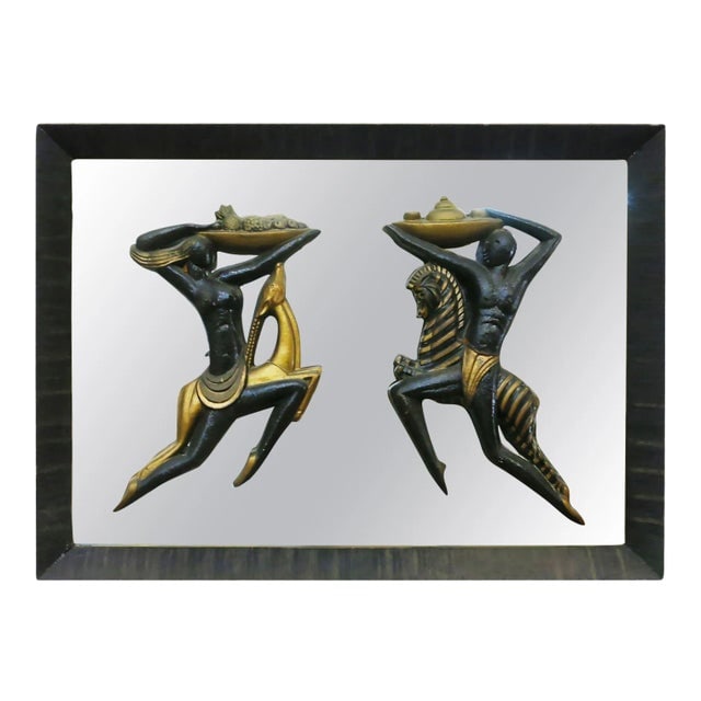 1950s Large Mid Century Wall Mirror With Carved Tribal Sculptures in the Center: Title: 1950s Large Mid Century Wall Mirror With Carved Tribal Sculptures in the Center Description: Original Mid-Century wall mirror with carved tribal male and female sculptures in the center surroun