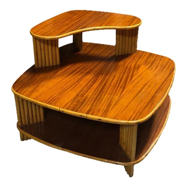 Restored Rattan 1940s Double Level Corner Table With Quatered Koa Wood Top: Title: Restored Rattan 1940s Double Level Corner Table With Quatered Koa Wood Top Description: The restored rattan corner table with a striking dimensional quartered koa wood top is a fusion of elegan
