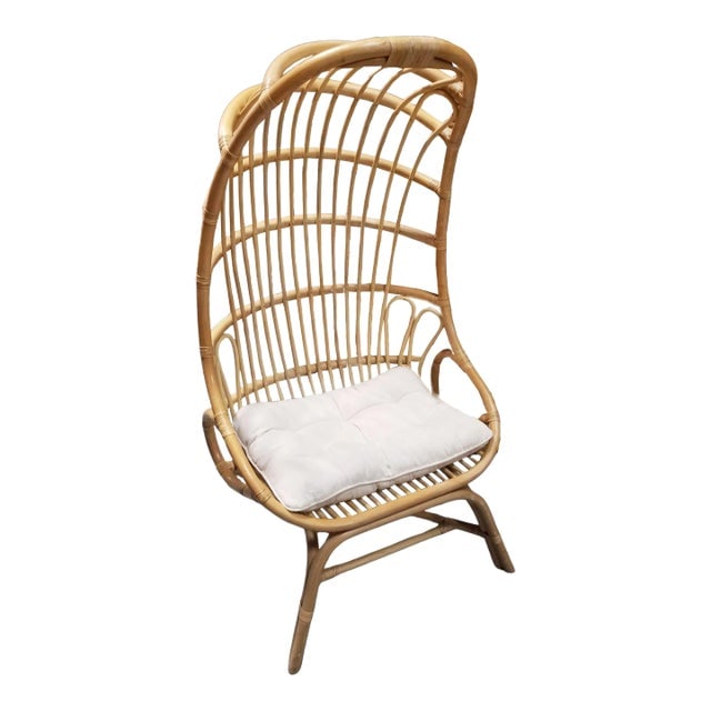 Rattan Cocoon Chair With Cushion: Title: Rattan Cocoon Chair With Cushion Description: The rattan cocoon chair is a fusion of nature and design, featuring intricate woven patterns that embrace you in comfort. Its curved silhouette cre