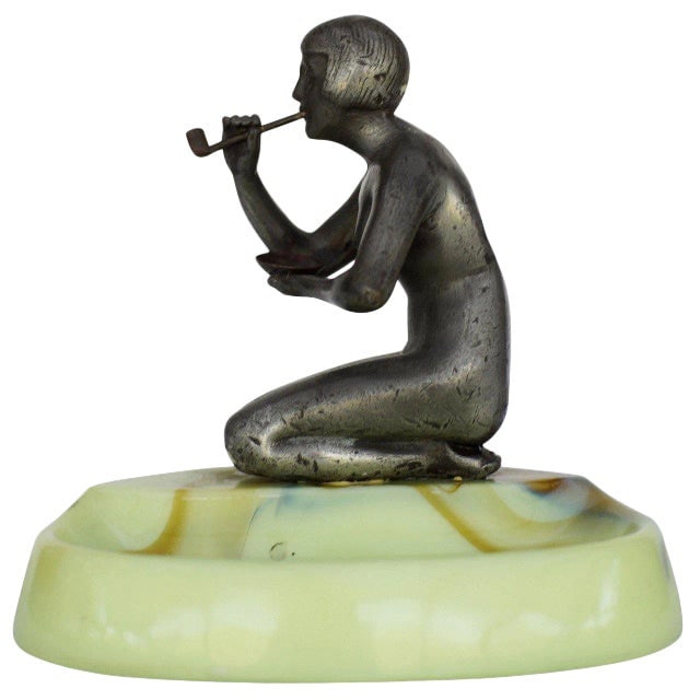 1930s figure Art Deco Smoking Flapper Slag Glass Ashtray by Houzex: Title: 1930s figure Art Deco Smoking Flapper Slag Glass Ashtray by Houzex Description: Made by Houzex, this brown and green slag ashtray features a spelter metal sculpture of a figure flapper girl smo