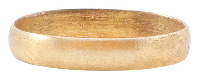 VIKING WARRIOR’S WEDDING RING, SIZE 8: Cambridgeshire England, 9th-11th century AD. Gilt bronze, size 8, 3.3mm width band with a well rounded face. Surface textured overall from burial. Vikings exchanged rings on the pommel of the groom's 