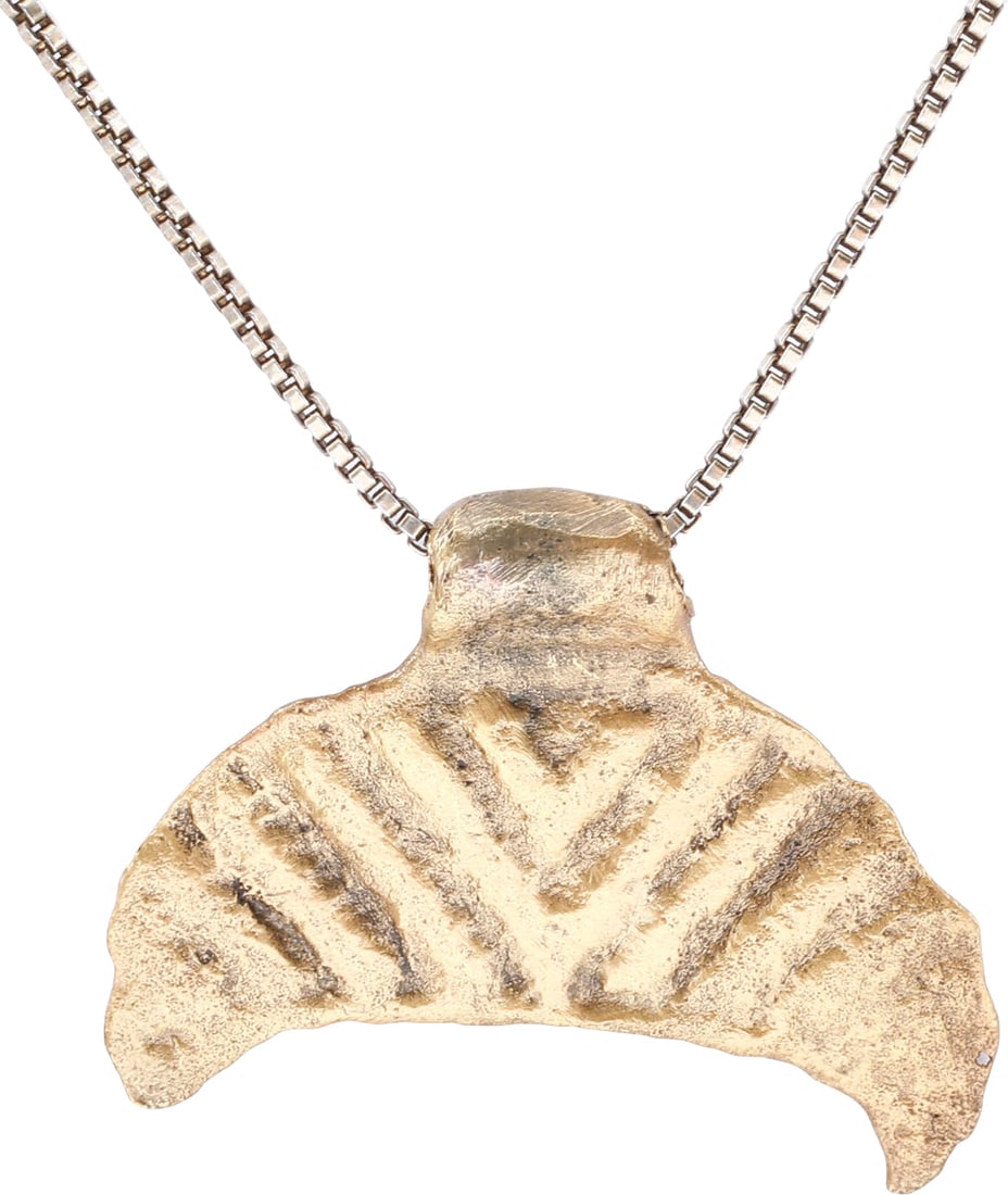 VIKING LUNAR PENDANT NECKLACE, 11TH CENTURY: Viking navigator's amulet representing the moon (Mani) in broad crescent form. The front with deep chevron pattern and the back plain. As navigators, the celestial bodies were sacred for the guidance 