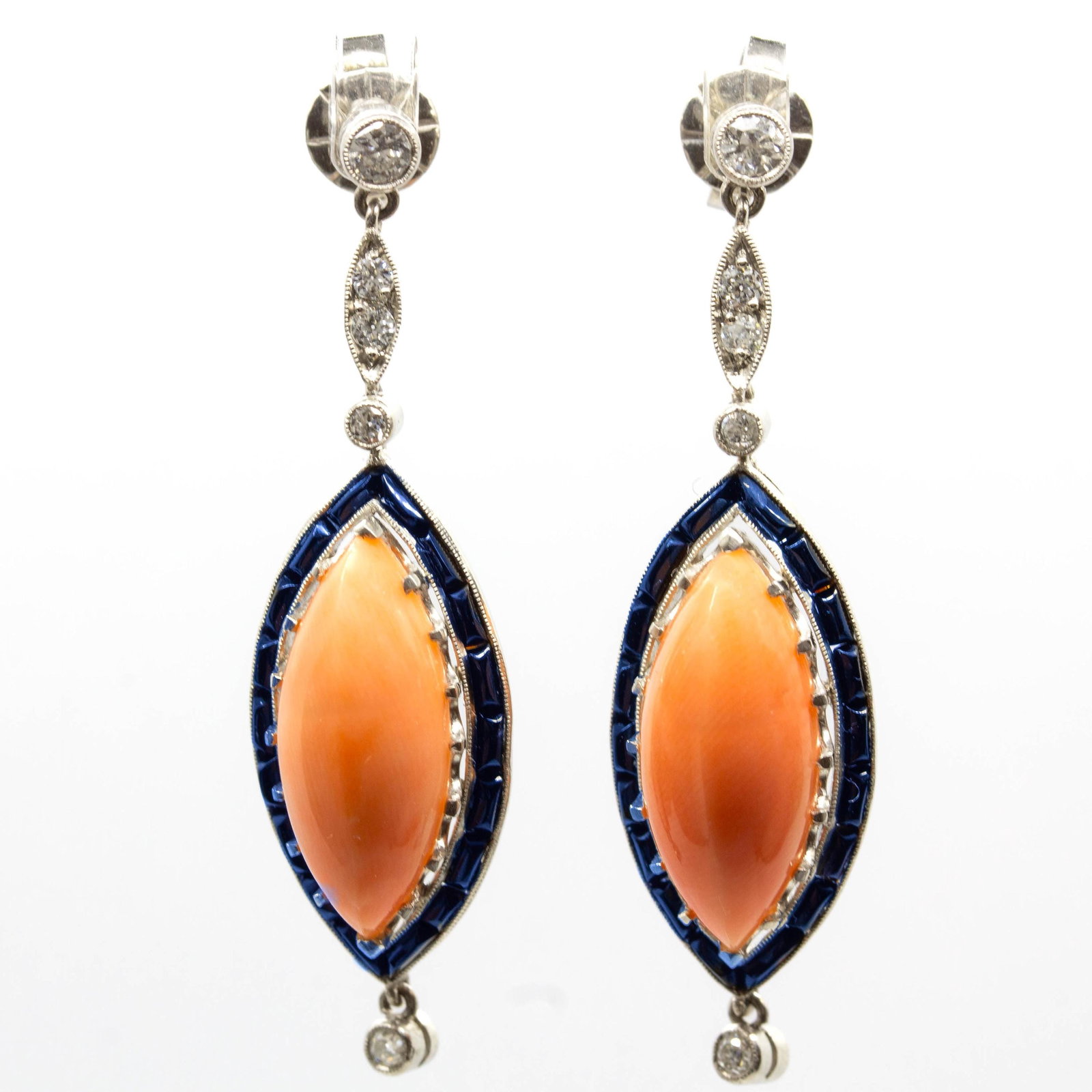 Edwardian Platinum Natural Coral, Calibrated Onyx, and Natural Diamond Earrings: The Britanny earrings are an authentic vintage piece from the Edwardian Era circa 1900. They center 2 natural marquise cut corals which are surrounded by 36 calibrated cut onyxes and 20 natural old mi