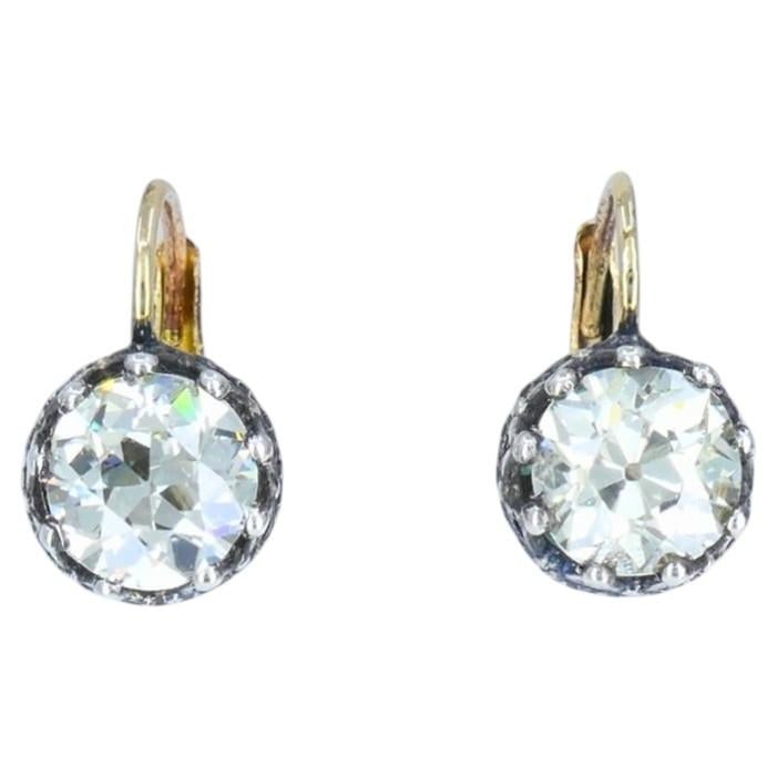 Victorian Diamond Drop Earrings 14k Gold Silver Old European Cut, Antique: A pair of Victorian diamond earrings made of 14k yellow gold and silver settings. The earrings feature two Old European cut diamonds weighing approximately 1.64-carat and 1.68-carat. Their hand-cut fa