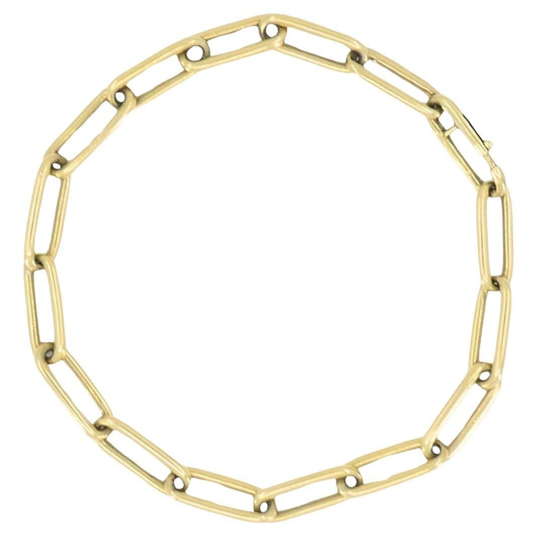 Vintage 14k Gold Paperclip Link Bracelet: This vintage Italian bracelet is crafted in 18K yellow gold and features a timeless paperclip link design. Each elongated link is slightly rounded, creating a fluid, refined silhouette that lies