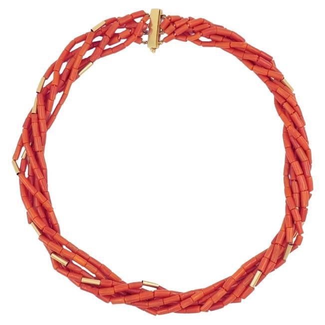Van Cleef and Arpels Necklace Multi-Strand 14k Gold Coral Beads: A vintage Van Cleef & Arpels necklace that comprises multiple strands of tubular coral and gold beads. The coral has a natural matte finish and a distinct red hue that gives it an earthy quality. Spac