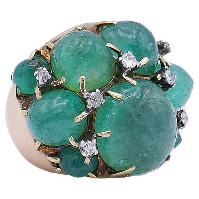 Vintage Ring 14k Gold Emerald Cocktail Estate Jewelry: A whimsical vintage ring made of 14 karat yellow gold featuring cabochon emerald. The cabochon emeralds are staged as a free form cluster, with a bigger stone in the middle. Being a part of the