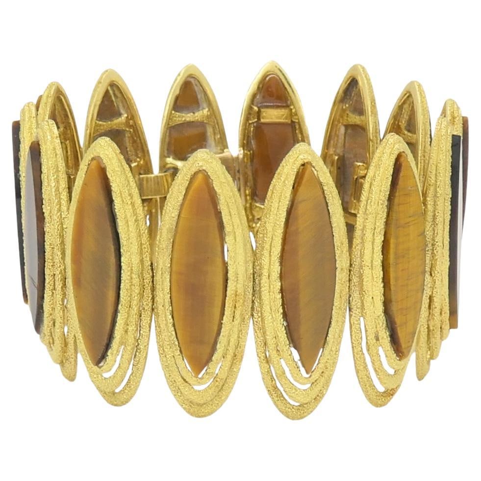 Vintage Kutchinsky Tiger’s Eye Bracelet 18k Gold: This vintage Kutchinsky bracelet is made in solid 18k gold and set with tiger’s eye links arranged in a repeating marquise shape. Each link is framed in textured gold, giving the bracelet