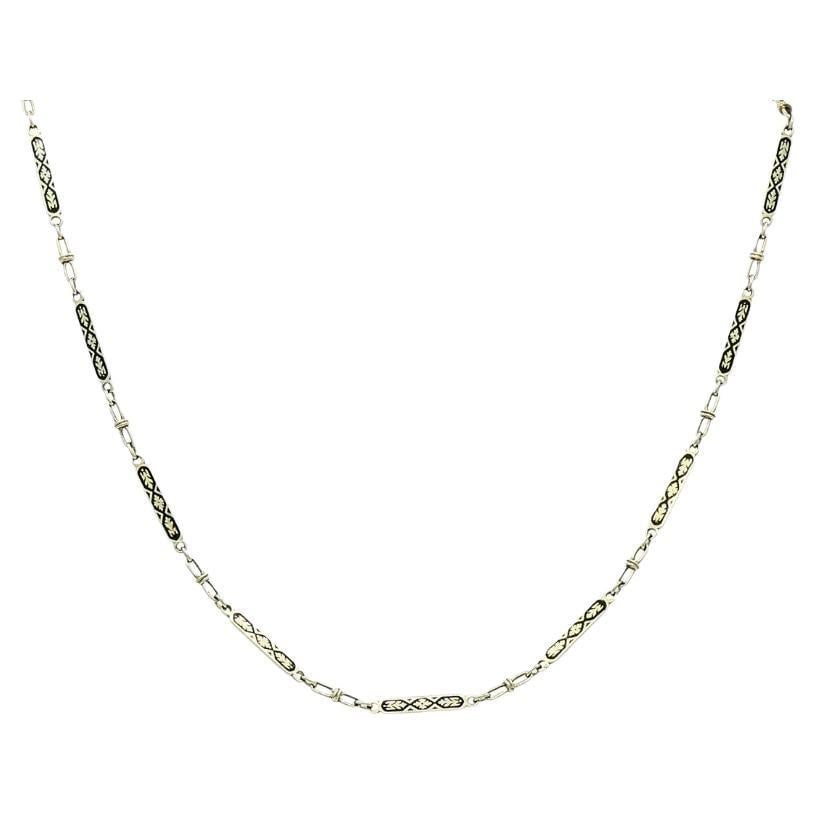 14k White Gold Chain Necklace Black Enamel: This vintage 14k white gold chain necklace features a delicate series of elongated, rectangular links decorated with black enamel in a repeating geometric pattern. Each enameled sections is framed by