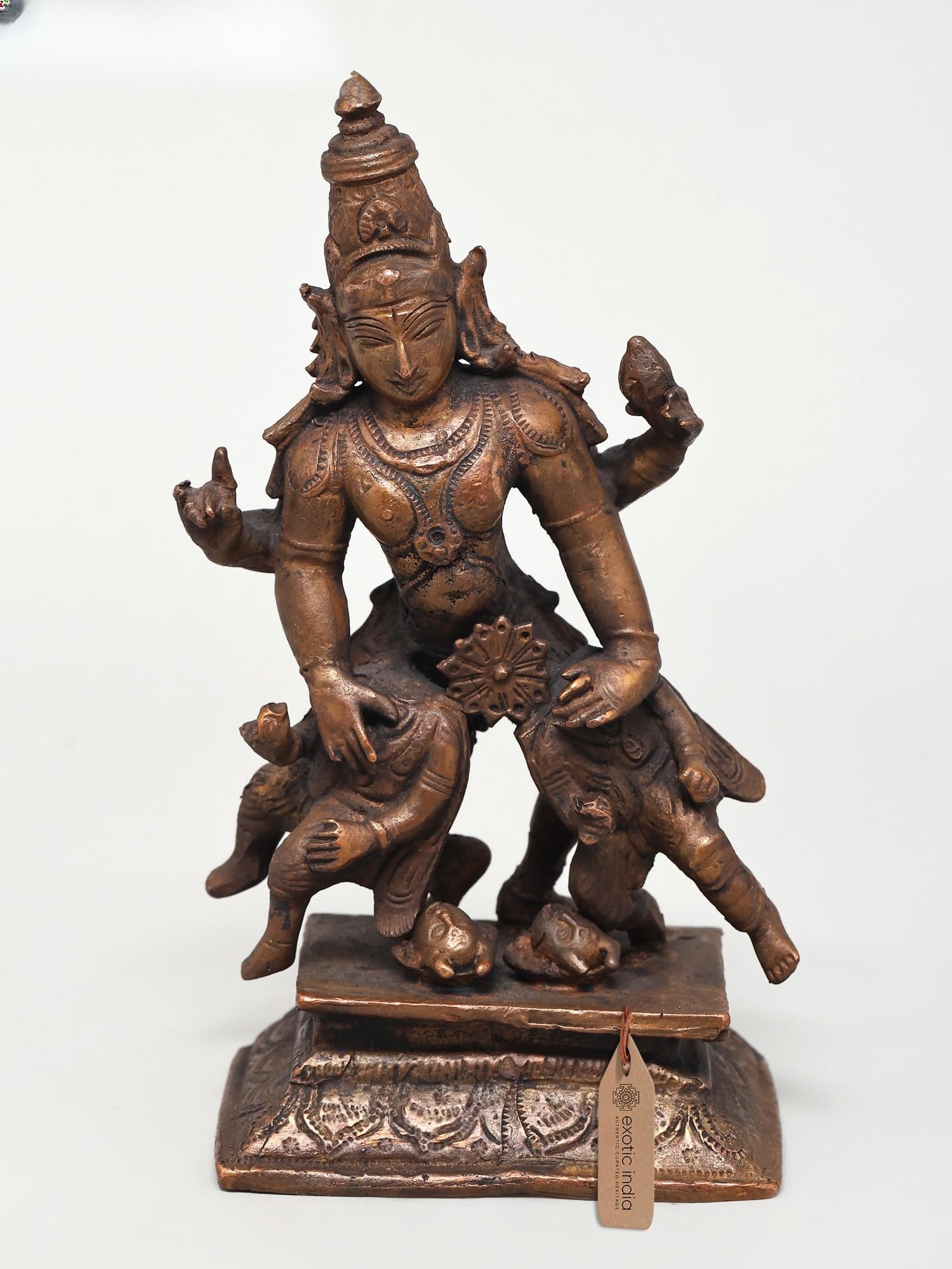6" Small Lord Vishnu Copper Idol - Asura Vadh with Sudarshan Chakra: Embodiment of Divine Justice and Protection This exquisite copper idol captures a powerful moment of divine intervention, depicting Lord Vishnu in his formidable aspect of vanquishing evil. Vishnu, on