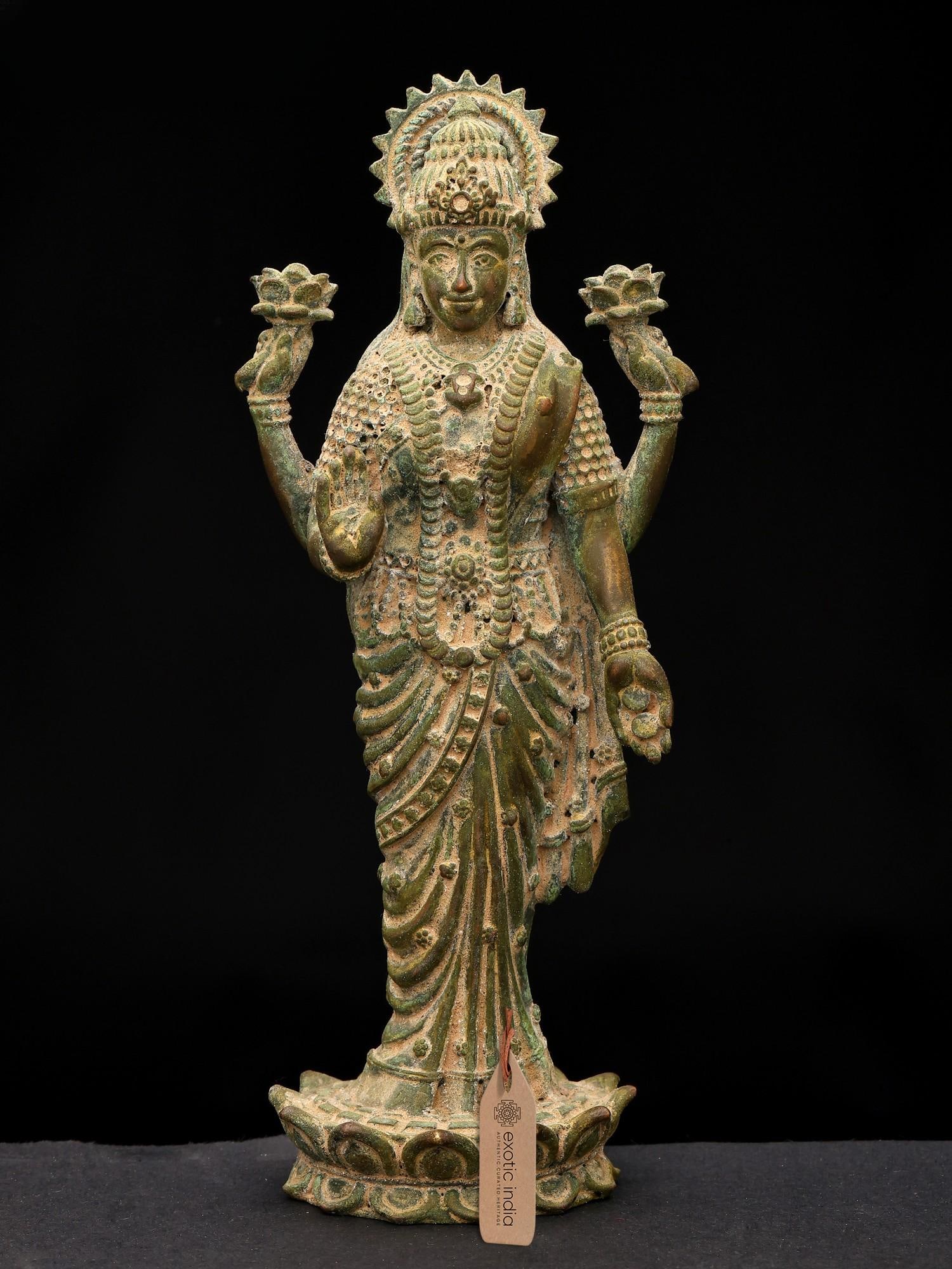 7" Standing Goddess Lakshmi in Blessing Gesture | Copper Statue: The Embodiment of Prosperity and Grace This exquisite copper statue captures the divine presence of Goddess Lakshmi, the revered deity of wealth, fortune, and prosperity in Hindu tradition. Standing