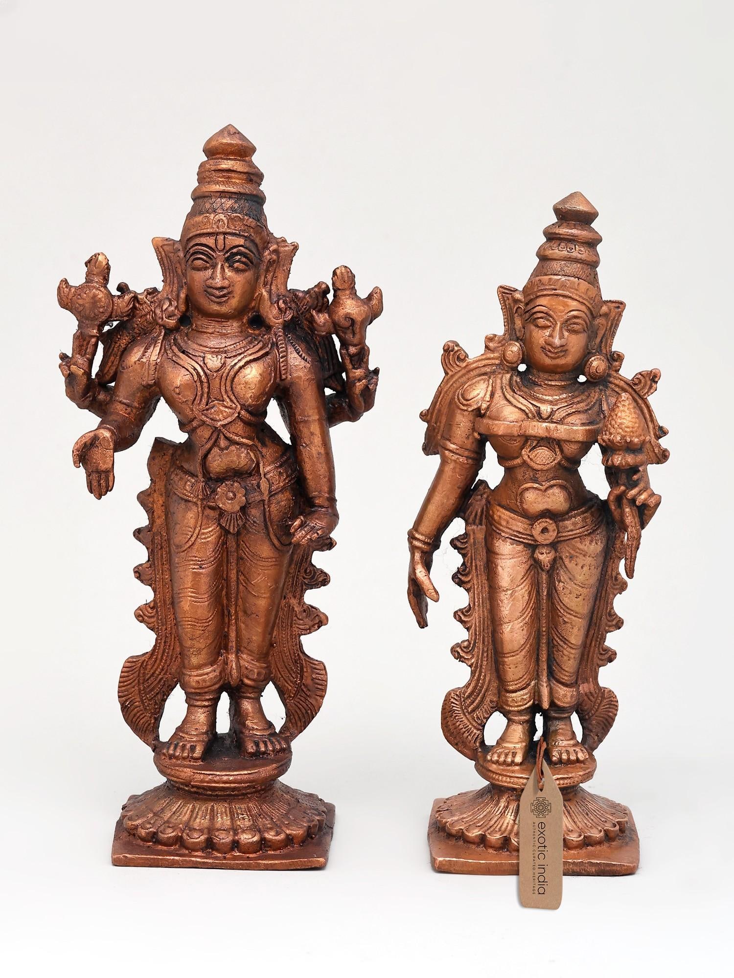 6" Small Standing Vishnu - Lakshmi Pair | Copper Statues: The Divine Union: Vishnu and Lakshmi in Copper This exquisite pair of copper statues depicts Lord Vishnu and his divine consort, Goddess Lakshmi, embodying the essence of cosmic order, prosperity, and