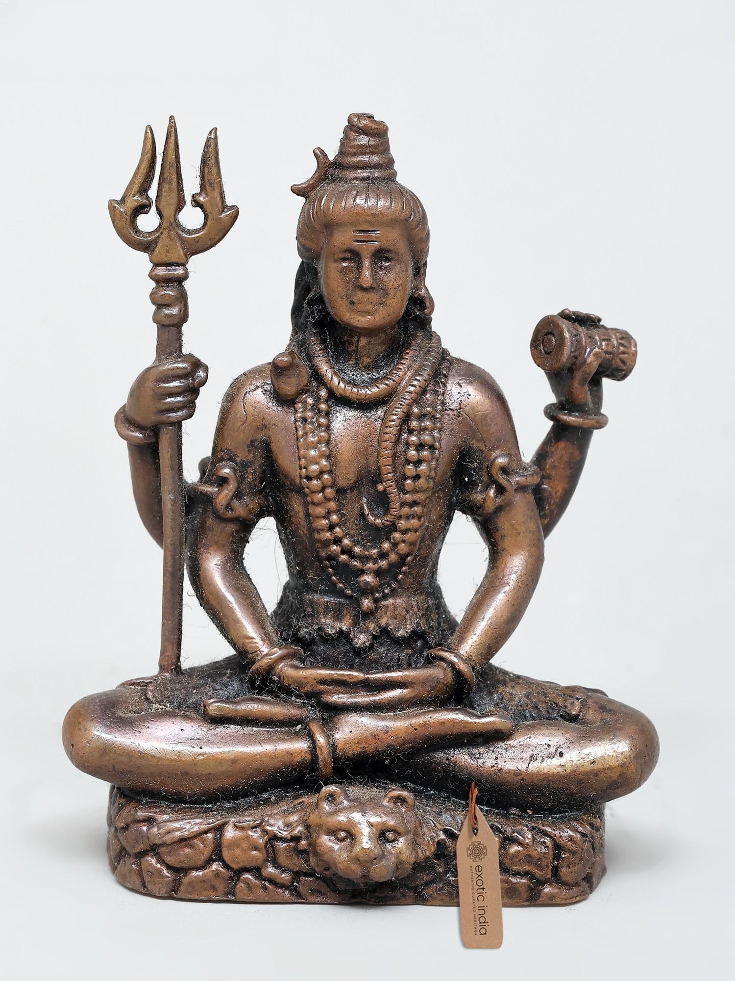 3" Small Four Armed Lord Shiva | Copper Statue: The Divine Presence of Lord Shiva This exquisite copper statue captures the serene and powerful essence of Lord Shiva, one of the principal deities of Hinduism. Seated in a meditative posture, this