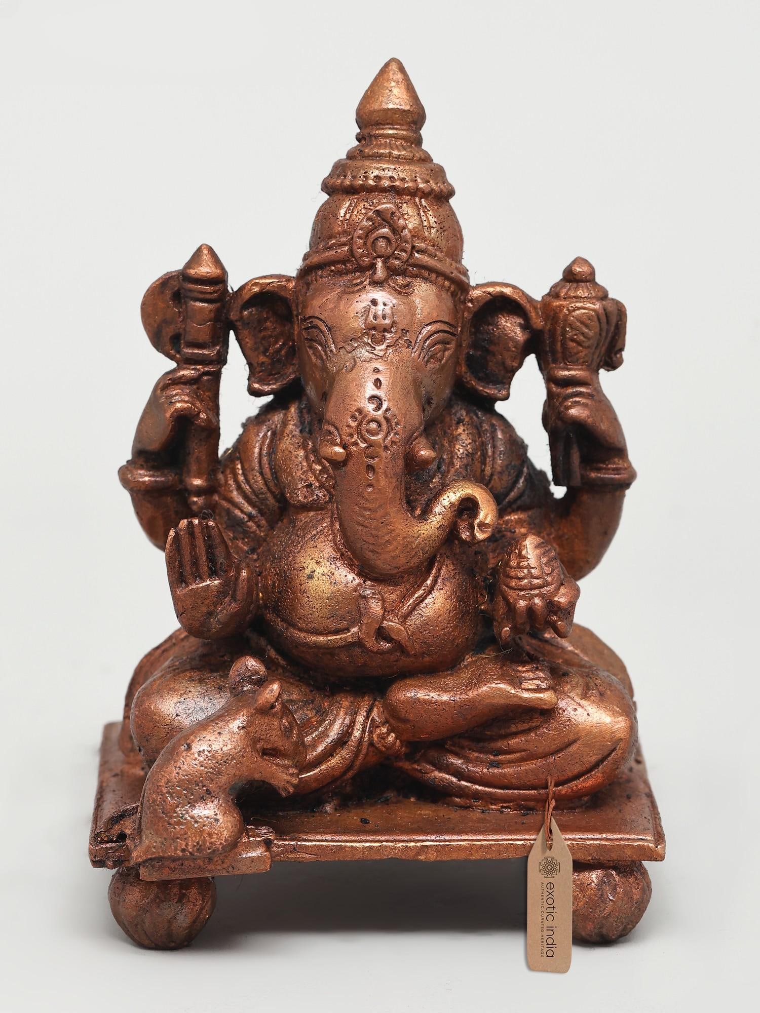 4" Small Four Armed Blessing Lord Ganesha | Copper Statue: The Divine Remover of Obstacles This exquisite copper statue captures the benevolent form of Lord Ganesha, the beloved elephant-headed deity revered as the remover of obstacles, the patron of arts