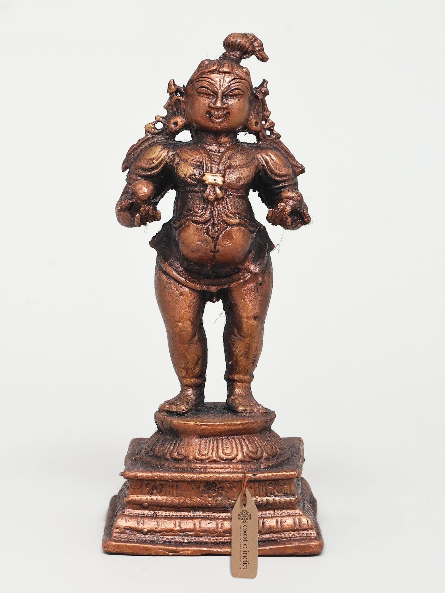4" Small Standing Bal Krishna | Copper Statue: The Divine Mischief of Bal Krishna This exquisite copper statue captures the playful and endearing spirit of Bal Krishna, the divine child form of Lord Krishna. Depicted in a standing posture, the