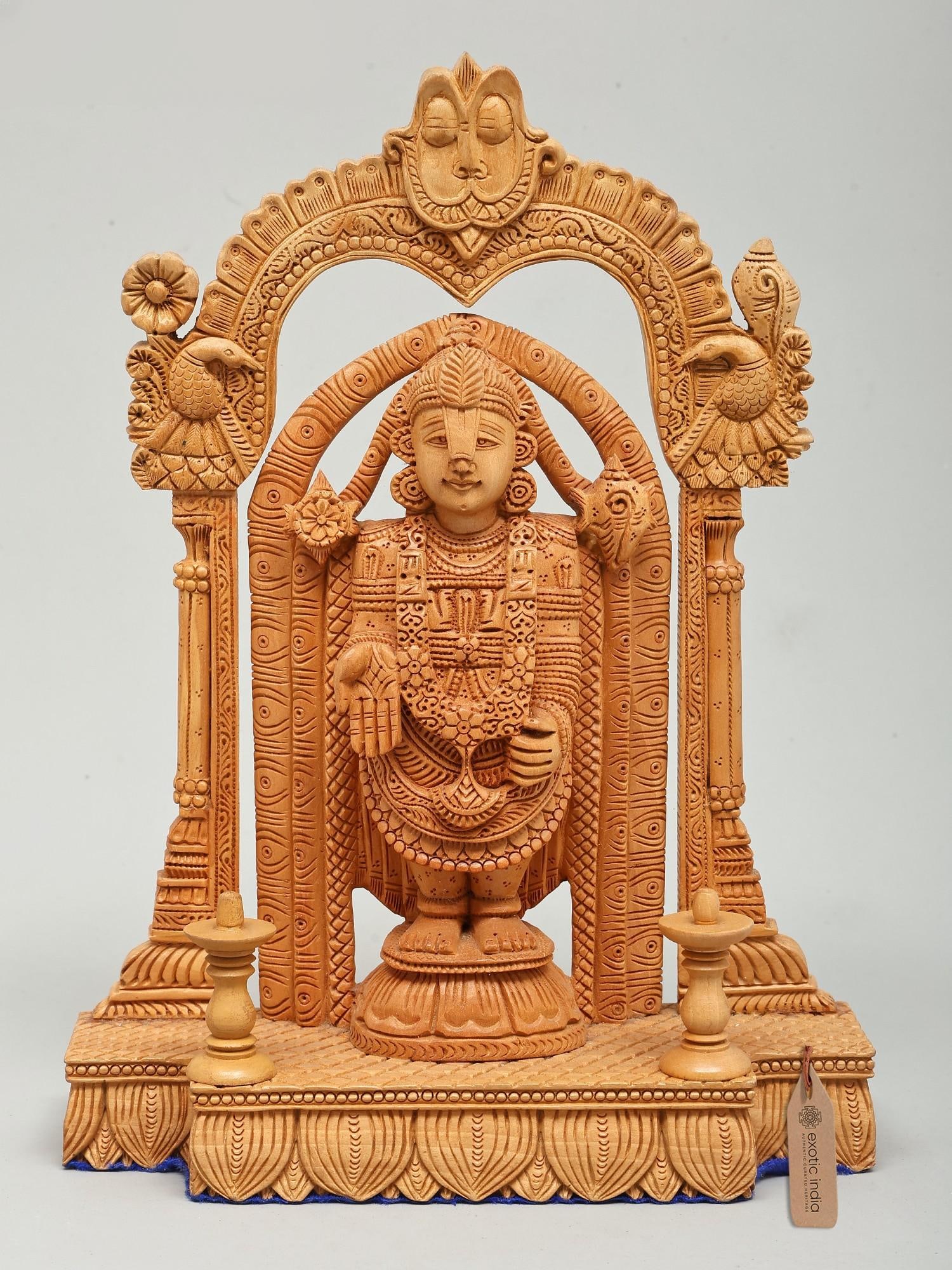 12" Standing Lord Tirupati Balaji (Venkateshvara) | Wood Carved Statue: The Divine Presence of Lord Venkateshwara This exquisite wooden carving brings the divine presence of Lord Venkateshwara, also known as Tirupati Balaji, into your sacred space. Standing at twelve