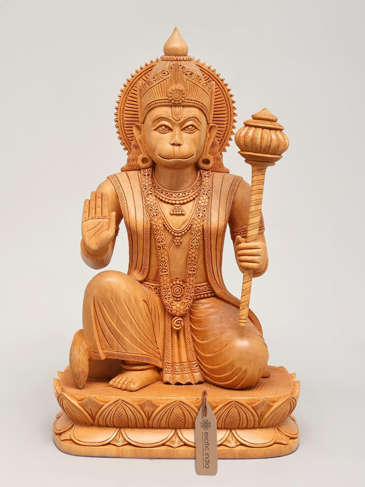 10" Lord Hanuman Seated in Blessing Gesture | Wood Carved Statue: Embodiment of Devotion and Strength This exquisite wooden carving captures the divine essence of Lord Hanuman, the devoted son of Vayu and the epitome of strength, courage, and unwavering loyalty.